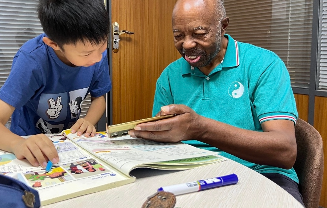 Teacher Joe with student Felix during an online English lesson